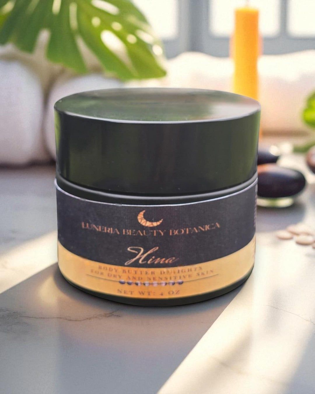 Cosmetic jar with 'Luneria Beauty Botanica' branding on a marble surface.