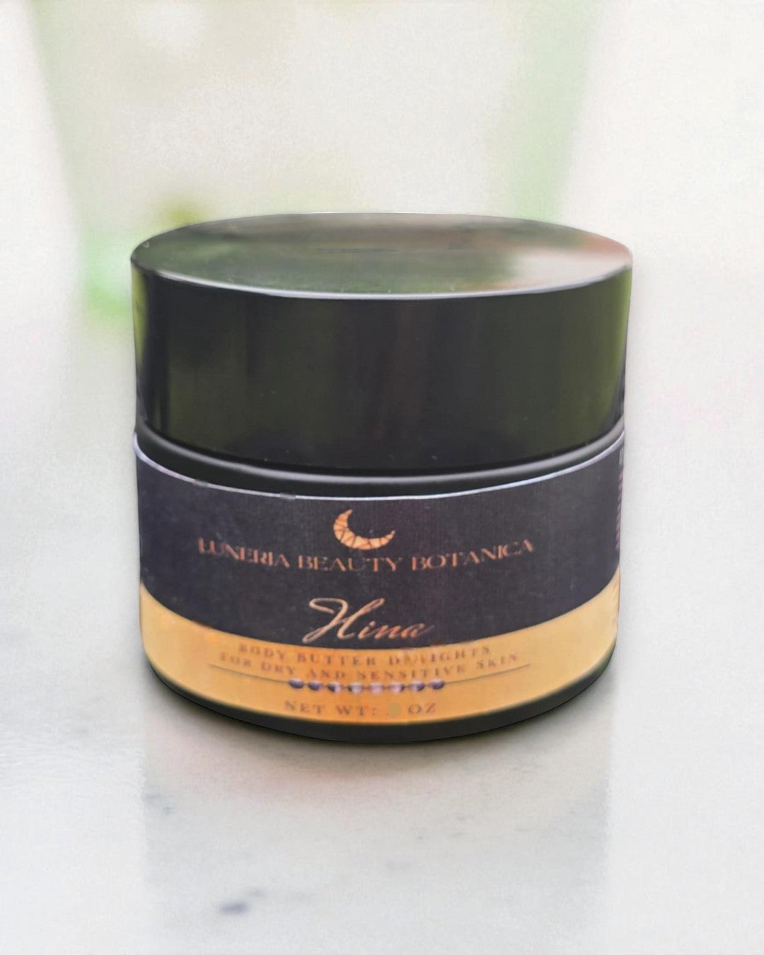 Jar of Luneria Beauty Botanica Hina body butter on a light background