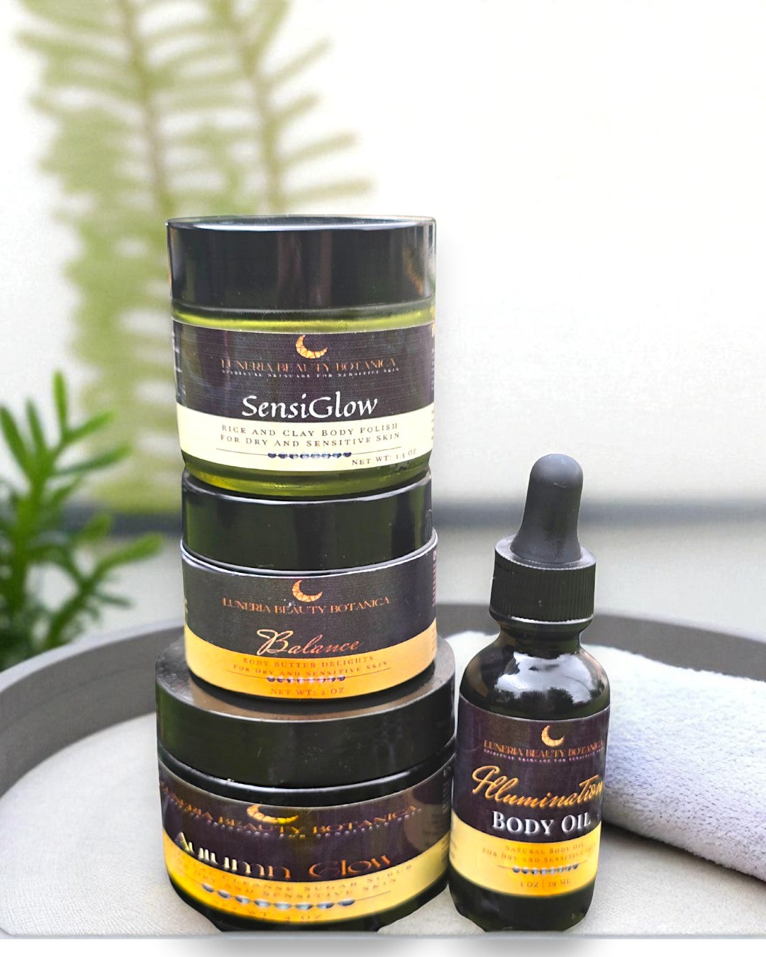 Stack of skincare products on a tray with a blurred background