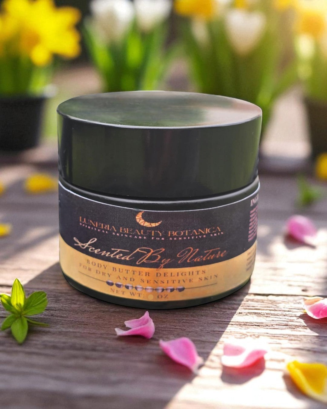 Jar of Luneria Beauty Botanica product on a wooden surface with flowers in the background