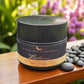 Cosmetic jar labeled 'Luneria Beauty Botanica' on a wooden surface with flowers in the background