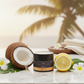 Jar of Hina body butter with coconut, lemon, and tropical leaves on a marble surface, coconut lemon scented moisturizer for sensitive skin